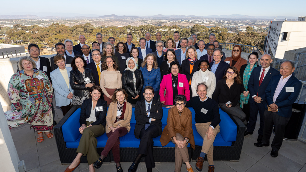 Attendees of the conference pictured with San Diego and mountains in the background