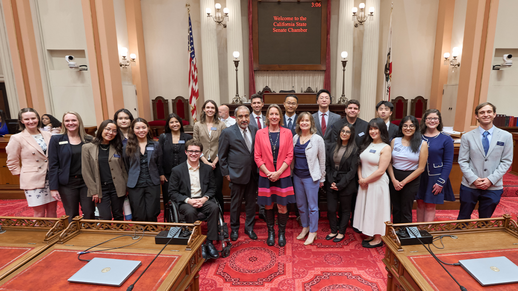 GPS students, UC San Diego Chancellor Pradeep Khosla and GPS Dean Caroline Freund pose for a picture with state Senator Catherine Blakespear in the California state Senate chamber